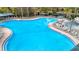 Resort-style pool with a spa and plenty of lounge chairs at 839 Manchester Woods Dr # 25, Sun City Center, FL 33573