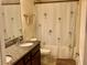 Bathroom includes a tub shower combo and palm-tree shower curtain at 87 Long Meadow Ln, Rotonda West, FL 33947