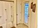 Bathroom with exterior access and a palm-tree shower curtain at 87 Long Meadow Ln, Rotonda West, FL 33947