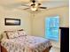 Cozy bedroom with a queen-size bed and ceiling fan at 87 Long Meadow Ln, Rotonda West, FL 33947