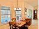 Bright dining area with a wooden table and chairs, and views of the pool at 87 Long Meadow Ln, Rotonda West, FL 33947