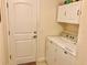 Bright laundry room with washer, dryer, and cabinets at 87 Long Meadow Ln, Rotonda West, FL 33947