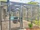 Screened pool enclosure with access gate at 87 Long Meadow Ln, Rotonda West, FL 33947