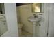 Small bathroom with pedestal sink and toilet at 9 Plaza E St, Bradenton, FL 34208