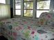 Small bedroom with window and patterned bedding at 9 Plaza E St, Bradenton, FL 34208