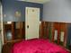 Bedroom with exposed walls and a red blanket on the bed at 9 Plaza E St, Bradenton, FL 34208