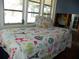 Small bedroom with window and patterned bedding at 9 Plaza E St, Bradenton, FL 34208