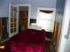 Small bedroom with a red blanket on the bed and closet at 9 Plaza E St, Bradenton, FL 34208