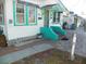 Front porch with teal steps and brick walkway at 9 Plaza E St, Bradenton, FL 34208