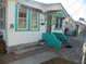 Front porch with teal accents and brick walkway at 9 Plaza E St, Bradenton, FL 34208