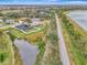 Aerial view showing home's location in a quiet community by a lake at 9100 Yarberry St, Sarasota, FL 34240