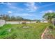 Landscaped backyard with green lawn, and mature trees at 9100 Yarberry St, Sarasota, FL 34240