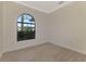 Bright bedroom featuring an arched window and wood-look floors at 9100 Yarberry St, Sarasota, FL 34240