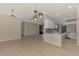 Dining room with wood-look floors and kitchen views at 9100 Yarberry St, Sarasota, FL 34240