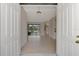 Bright and airy entryway with light wood floors and view of pool at 9100 Yarberry St, Sarasota, FL 34240