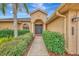 Front entry with double doors, lush landscaping, and walkway at 9100 Yarberry St, Sarasota, FL 34240