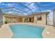 Large, kidney-shaped pool with a screened enclosure at 9100 Yarberry St, Sarasota, FL 34240