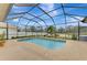 Sparkling pool with screened enclosure and backyard view at 9100 Yarberry St, Sarasota, FL 34240