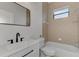 Clean bathroom with white vanity and beige tile at 9100 Yarberry St, Sarasota, FL 34240