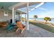 Relaxing waterfront deck features tiled flooring and outdoor seating at 10428 Marion St, Englewood, FL 34224