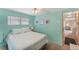 Serene bedroom with a queen-size bed and access to hallway at 1108 43Rd Avenue E Dr, Ellenton, FL 34222