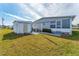 Grey house with a shed and a grassy backyard at 1108 43Rd Avenue E Dr, Ellenton, FL 34222