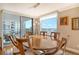 Elegant dining room featuring hardwood floors and bay views at 1111 N Gulfstream Ave # 14C, Sarasota, FL 34236