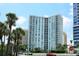 High rise building with water views and palm trees at 1111 N Gulfstream Ave # 14C, Sarasota, FL 34236