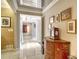 Elegant hallway with tiled floors and ornate wooden cabinet at 1111 N Gulfstream Ave # 14C, Sarasota, FL 34236