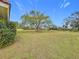 Spacious backyard featuring a large tree and grassy lawn at 121 Van Dyck Dr # Dr, Nokomis, FL 34275