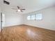 Large bedroom with wood floors and a ceiling fan and window at 121 Van Dyck Dr # Dr, Nokomis, FL 34275