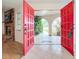 Inviting entryway with red double doors leading to a covered patio and walkway at 121 Van Dyck Dr, Nokomis, FL 34275