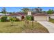 Single-story house with red front door and tile roof at 121 Van Dyck Dr, Nokomis, FL 34275