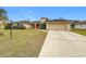 Single-story home with red tile roof and a large driveway at 121 Van Dyck Dr # Dr, Nokomis, FL 34275