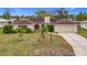 Single story house with red front door, tile roof, and palm trees at 121 Van Dyck Dr, Nokomis, FL 34275