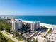 Aerial view of luxurious beachfront condo building and surroundings at 1212 Benjamin Franklin Dr # 305, Sarasota, FL 34236