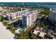 Aerial view of condo building near beach and water at 1212 Benjamin Franklin Dr # 305, Sarasota, FL 34236