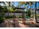 Relaxing courtyard with fountain, arbor, and lush tropical landscaping at 1212 Benjamin Franklin Dr # 305, Sarasota, FL 34236