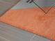 Close-up view of a stylish burnt orange rug at 1212 Benjamin Franklin Dr # 305, Sarasota, FL 34236