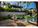 Serene courtyard garden with fountain and seating at 1212 Benjamin Franklin Dr # 305, Sarasota, FL 34236