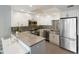 Modern kitchen with stainless steel appliances and granite countertops at 1212 Benjamin Franklin Dr # 305, Sarasota, FL 34236