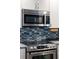 Stainless steel microwave above the stove at 1212 Benjamin Franklin Dr # 305, Sarasota, FL 34236