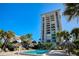 Heated pool with tropical landscaping and building view at 1212 Benjamin Franklin Dr # 305, Sarasota, FL 34236