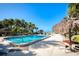 Inviting heated pool with tropical landscaping and beach access at 1212 Benjamin Franklin Dr # 305, Sarasota, FL 34236