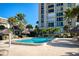 Resort-style pool with lush landscaping and building view at 1212 Benjamin Franklin Dr # 305, Sarasota, FL 34236