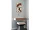 Floating wood vanity with a small stool and art at 1212 Benjamin Franklin Dr # 305, Sarasota, FL 34236