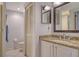 Bathroom with granite countertop and a shower at 1260 Dolphin Bay Way # 303, Sarasota, FL 34242