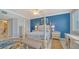 Bedroom with blue walls and a comfortable bed at 1260 Dolphin Bay Way # 303, Sarasota, FL 34242