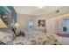 Bedroom with a king-size bed and seashell bedding at 1260 Dolphin Bay Way # 303, Sarasota, FL 34242