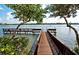 Wooden dock with benches, providing waterfront access and peaceful water views at 1260 Dolphin Bay Way # 303, Sarasota, FL 34242